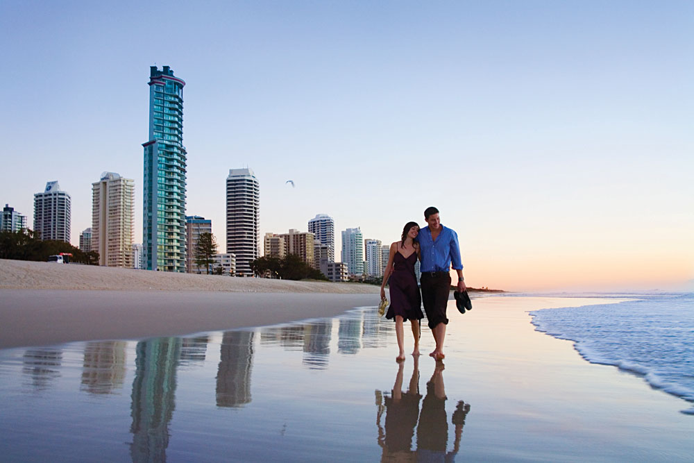 Couple Walking at Sunset Along Surfers Paradise Beach, Gold Coast, Queensland, Australia