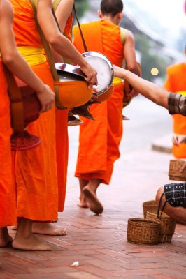 Giving alms to Buddhist monks