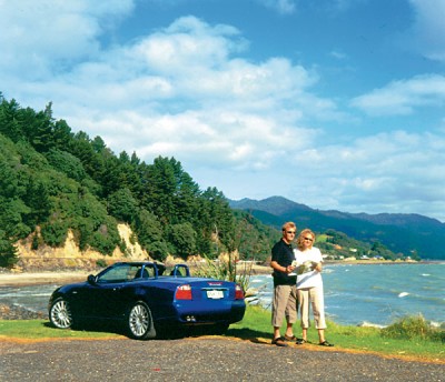 Couple with Car and Map, New Zealand