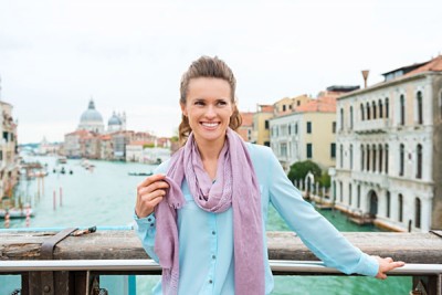 Elegant Woman Tourist Holds Scarf and Smiling, Venice, Italy_314298872