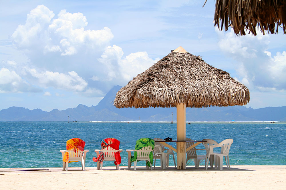 Three Colorful Chairs Aligned on a Beach in Papeete, Tahiti, French Polynesia