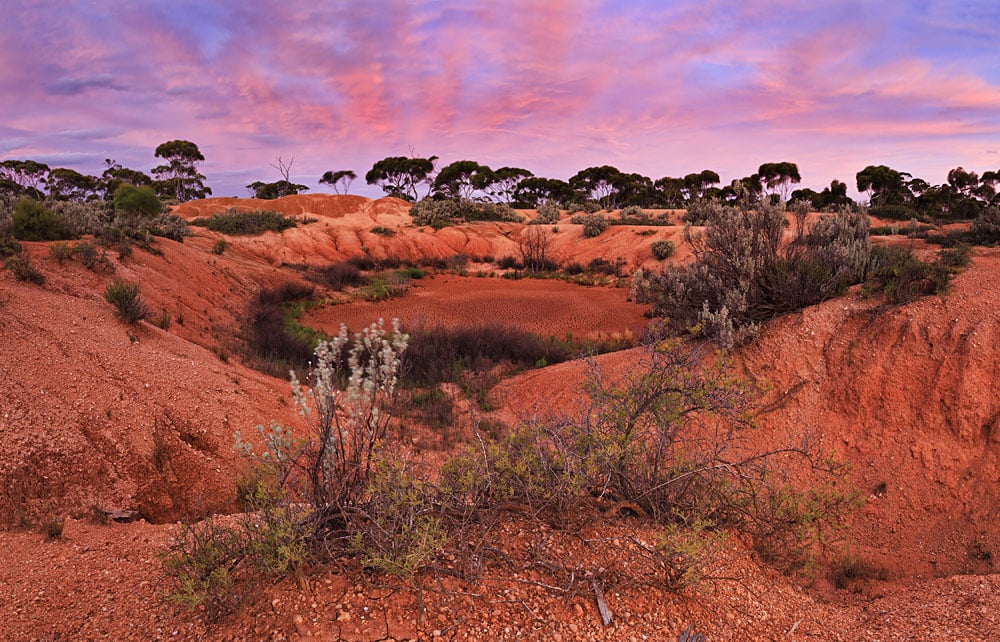 Dried Water Hole in Red Soil of the Australian Outback in Arnhem Land at Sunset, Northern Territory, Australia