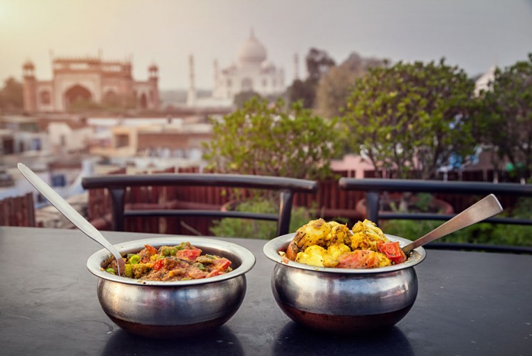 Traditional Indian food in Metal Dish on Rooftop Restaurant with Taj Mahal Background, Agra, Uttar Pradesh, India