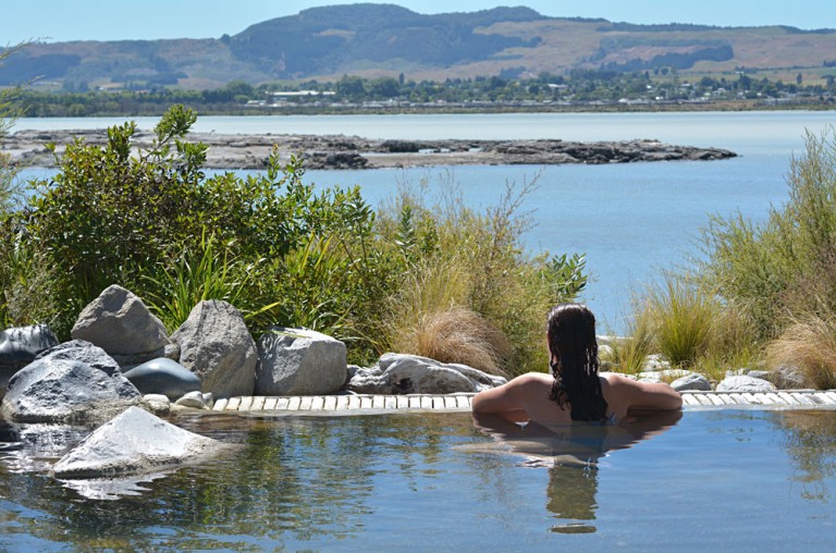 Woman Relaxing in Hot Pool in Rotorua, New Zealand