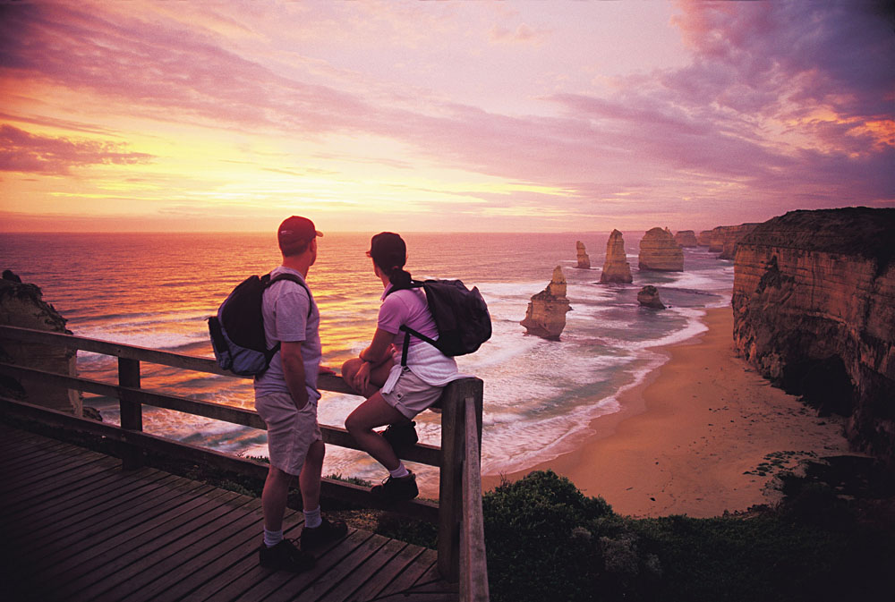 Couple Looking Out at the Twelve Apostles at Sunset, Victoria, Australia