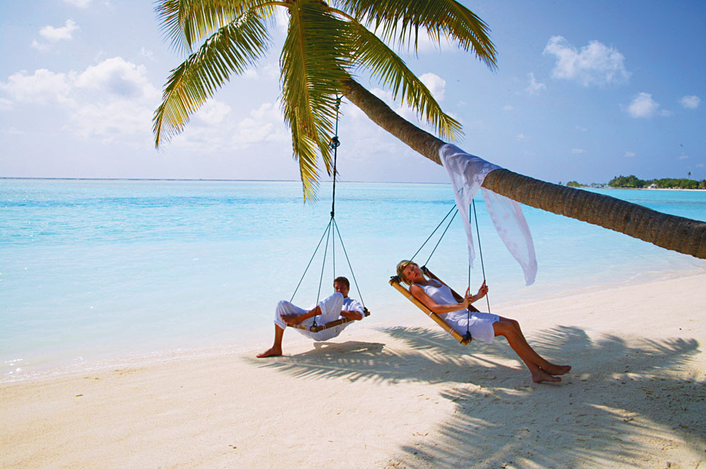 Couple Relaxing on a Tree Swing in the Maldives