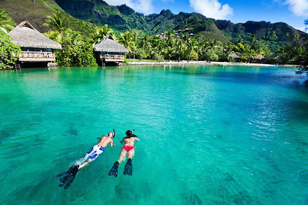 Young Couple Snorkeling in Moorea in Tahiti (French Polynesia)
