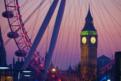 Big Ben Tower and the Houses of Parliament seen through Millennium Wheel or London Eye at dusk from Waterloo Bridge