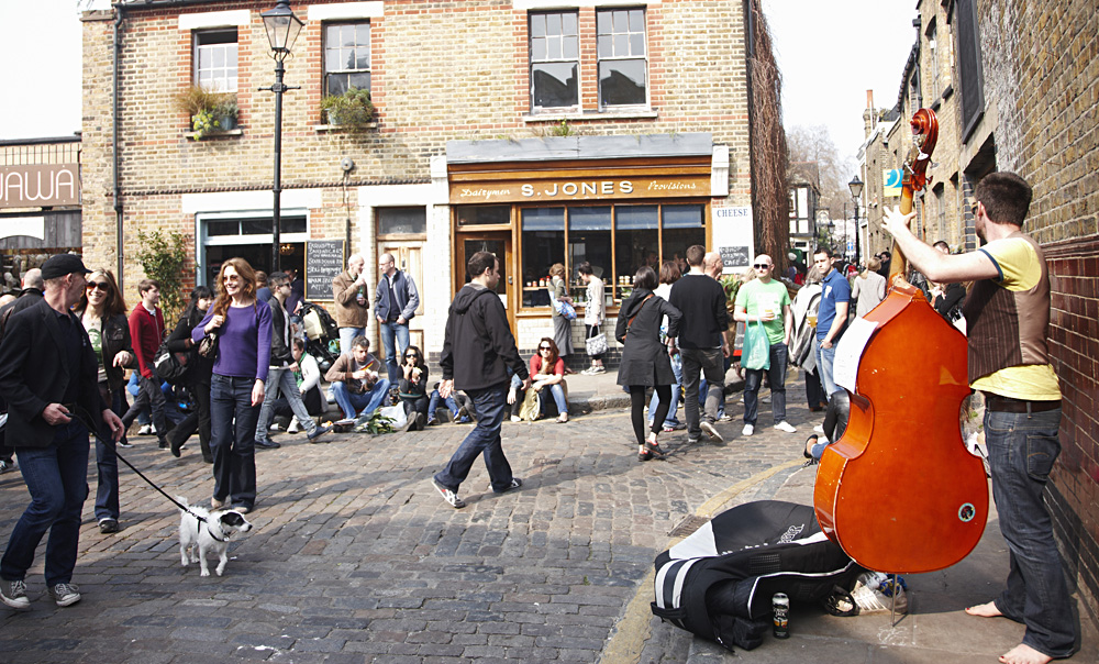 People enjoying the Sunday atmosphere at Columbia Road Flower Market in Hackney, London, England, UK