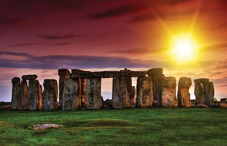 Sunset at Stonehenge with Dramatic Sky and Sun Rays, England, UK