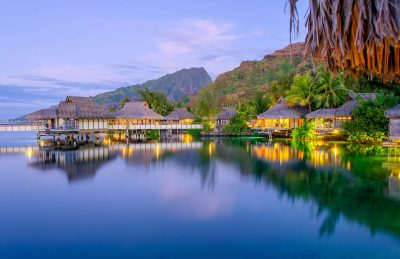 Overwater bungalows at dusk, Tahiti Vacations