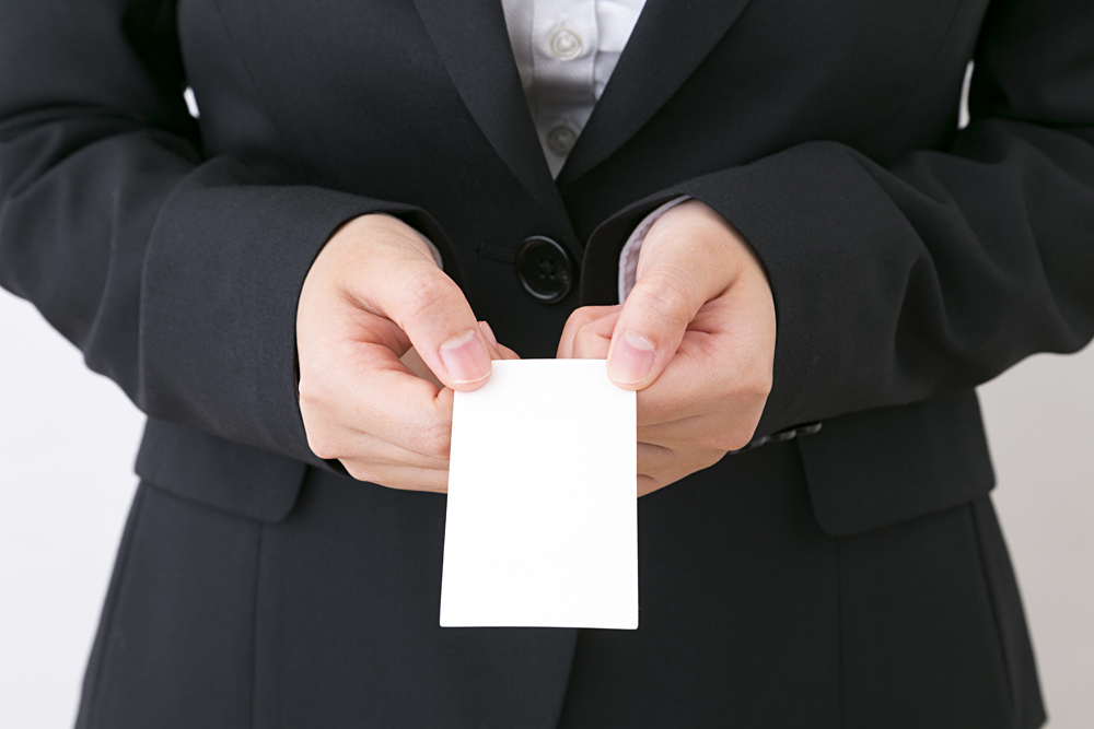 Business Woman Handing Over a Business Card with Both Hands, Japan