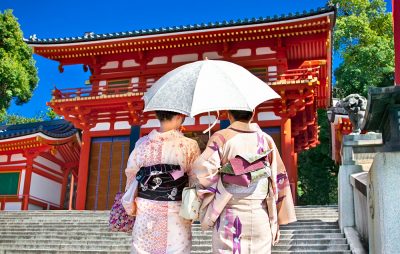 Japanese Girls in Traditional Clothing Walking in the Yasaka-Jinja Shrine in Kyoto, Japan