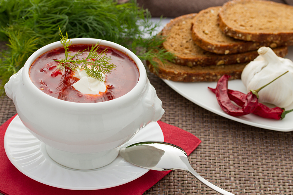 Russian Borscht in White Bowl with Dill and Bread Slices