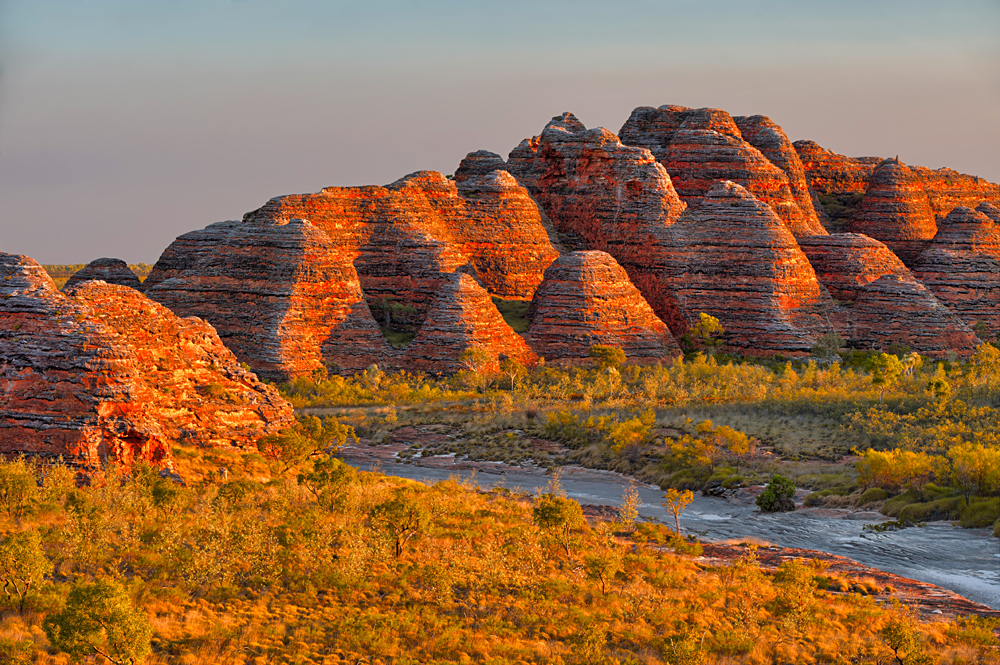 Beehives and Piccaninny Creek in warm evening light, Bungle Bungles National Park, Western Australia, Australia
