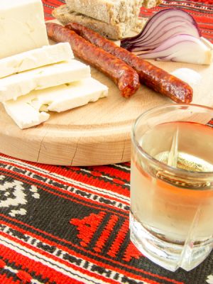 Traditional Romanian Snack of Cheese, Onion, Sausage, Bread and Plum Brandy (Tuica), Romania