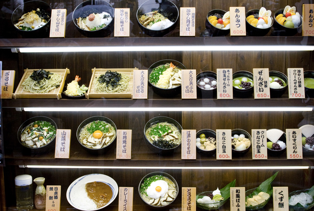 Plastic examples of menus in restaurant window display of a typical restaurant in Japan