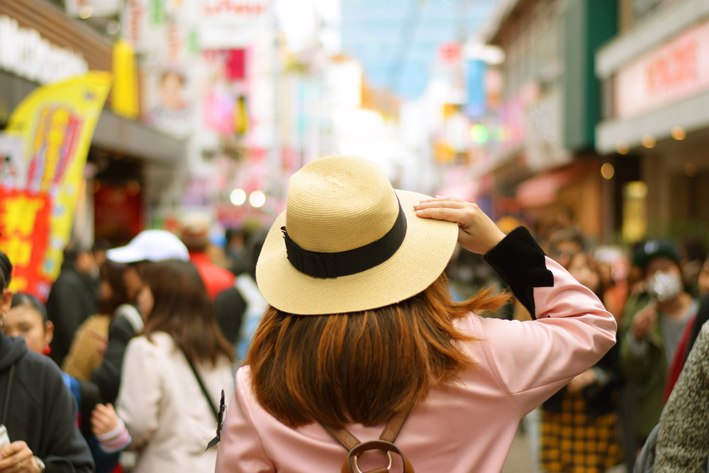 Woman Tourist Walking on Takeshita Street in Harajuku District, Tokyo, Japan