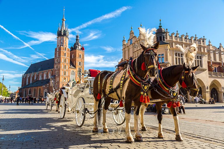 Horse Carriages at Main Market Square in Krakow in a summer day, Poland