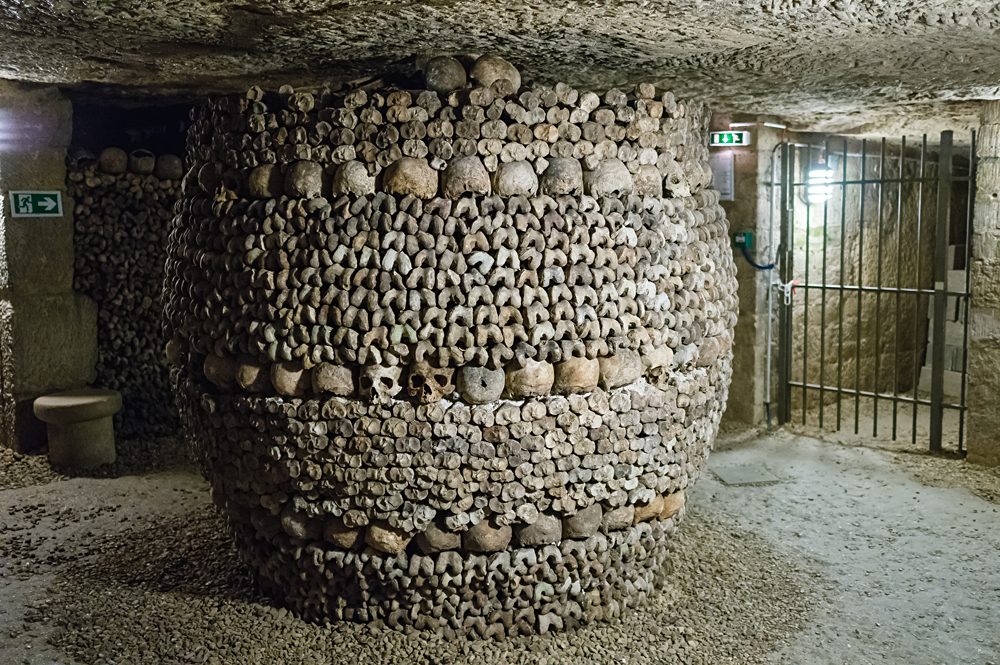 A pillar decorated by skull and bones in the Paris Catacombs, France