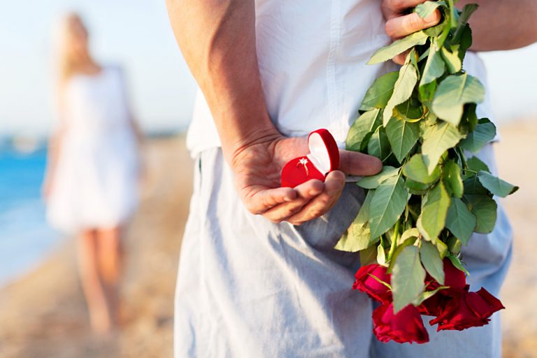 Beach Proposal Anticipated with Ring and Roses