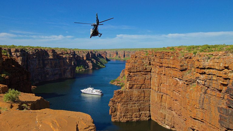 True North Adventure Cruise - Helicopter inbound over King George River, Kimberley, Western Australia, Australia