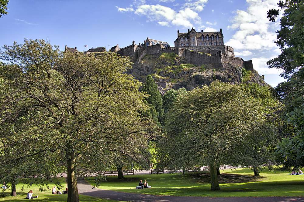 Edinburgh Castle perched on Castle Rock, overlooking the city park, Edinburgh, Scotland, UK (United Kingdom)