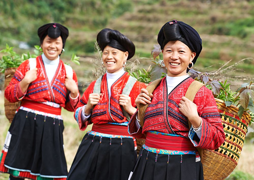 Group of happy chinese minority woman Yao in traditional dresses, Village of Longshen, China