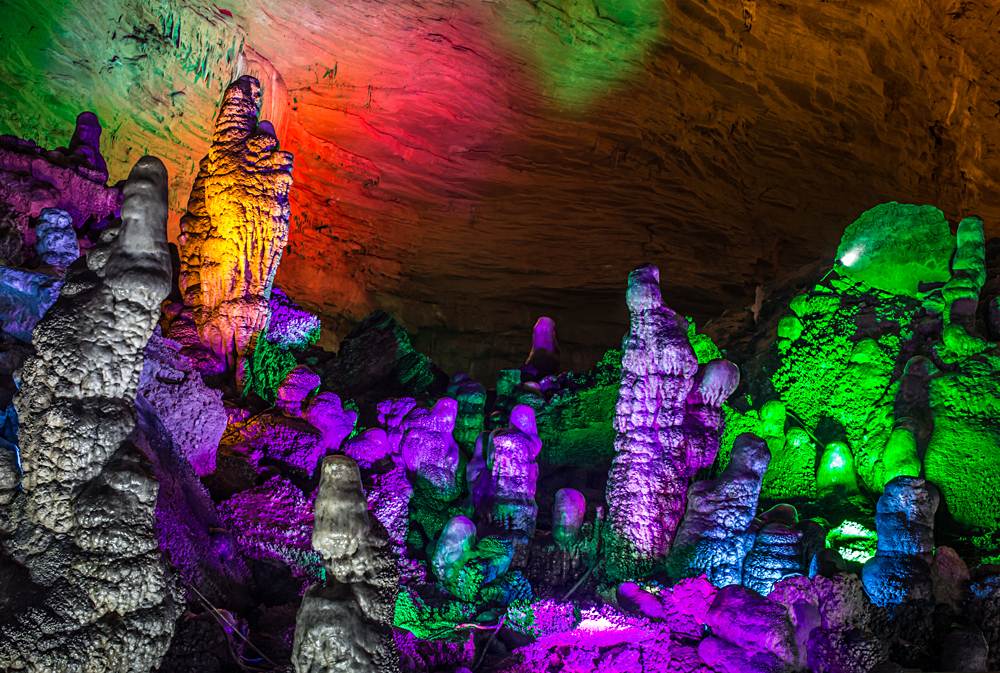 Illuminated multicoloured stalactites from karst in Reed Flute Cave, Guilin, Guangxi, China