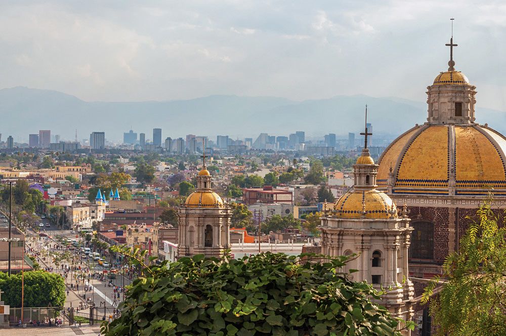 Old Basilica of Guadalupe with Mexico City skyline in Background, Mexico