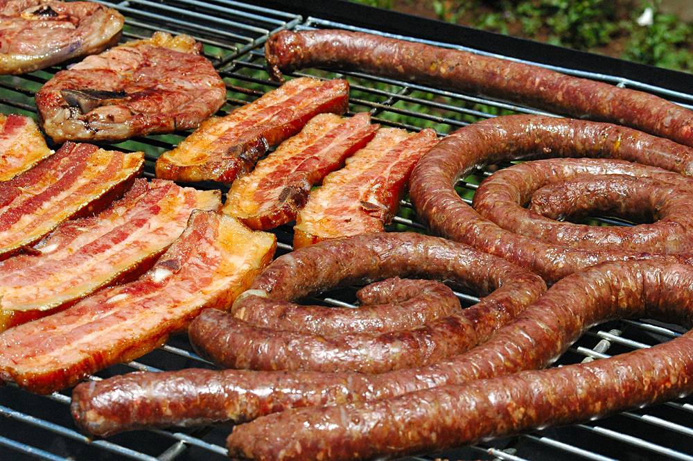 Grilling meats, including boerewors at a South African Braai, South Africa