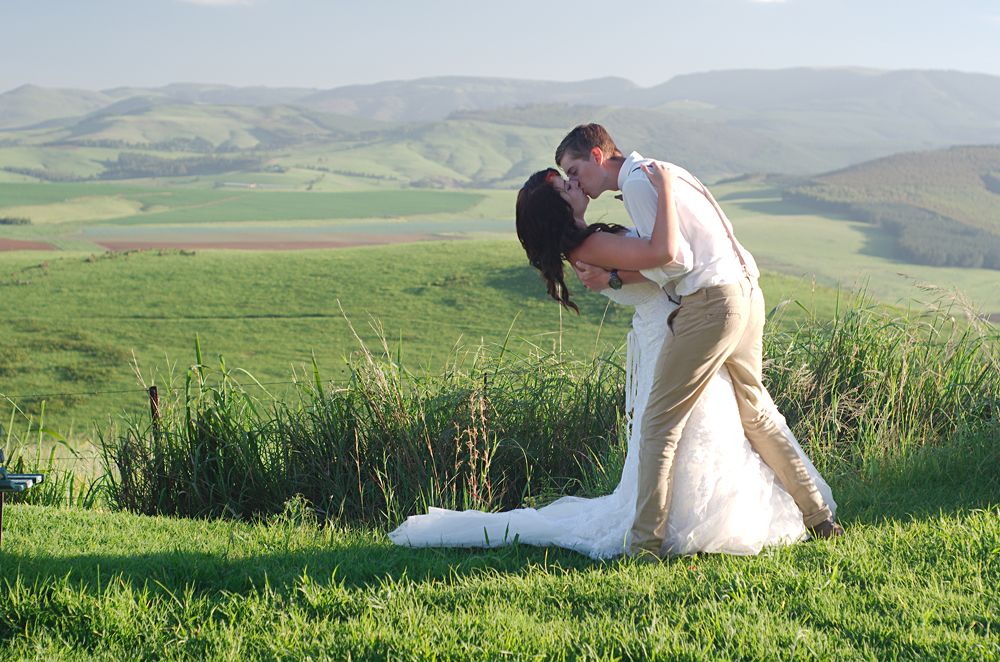 Bride and groom with African Natal Midlands mountain scenery, South Africa