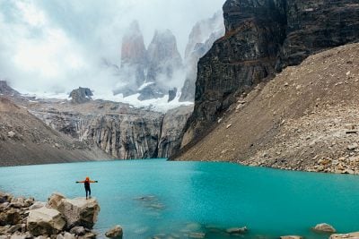 Man standing in front of Torres del Paine, Patagonia, Chile