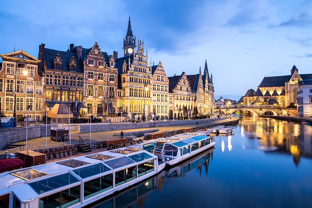 Picturesque medieval buildings at dusk on Leie river in Ghent town, Belgium