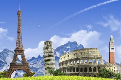 Summer travel across Europe - famous landmarks and grassy hill over blue sky