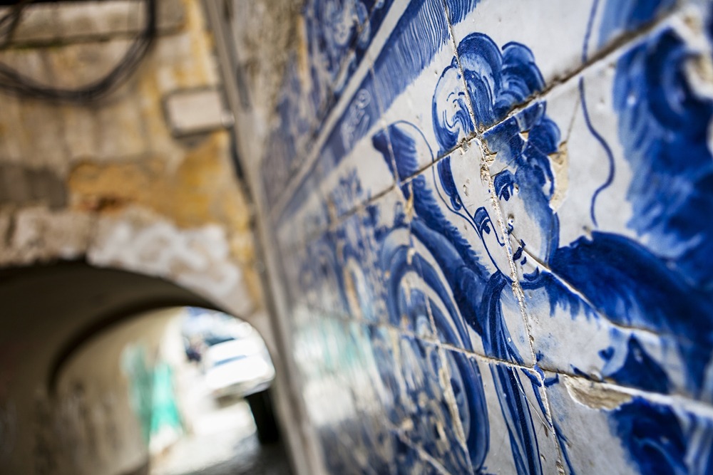 An angel figure in azulejo tiles in an alley in Lisbon, Portugal