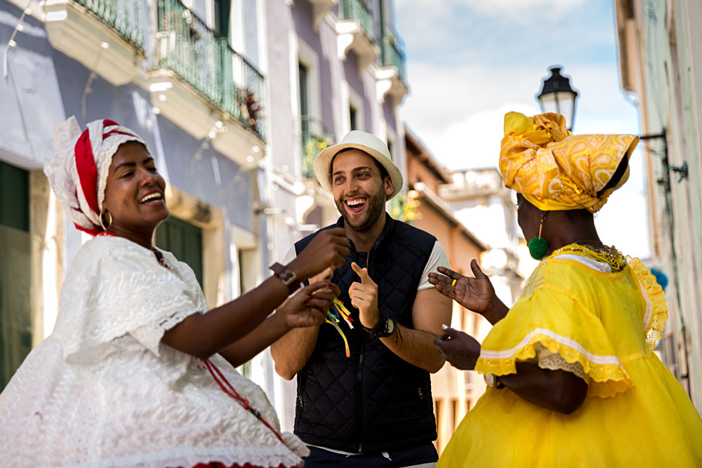 Tourist dancing with local Baianas in Salvador, Bahia, Brazil