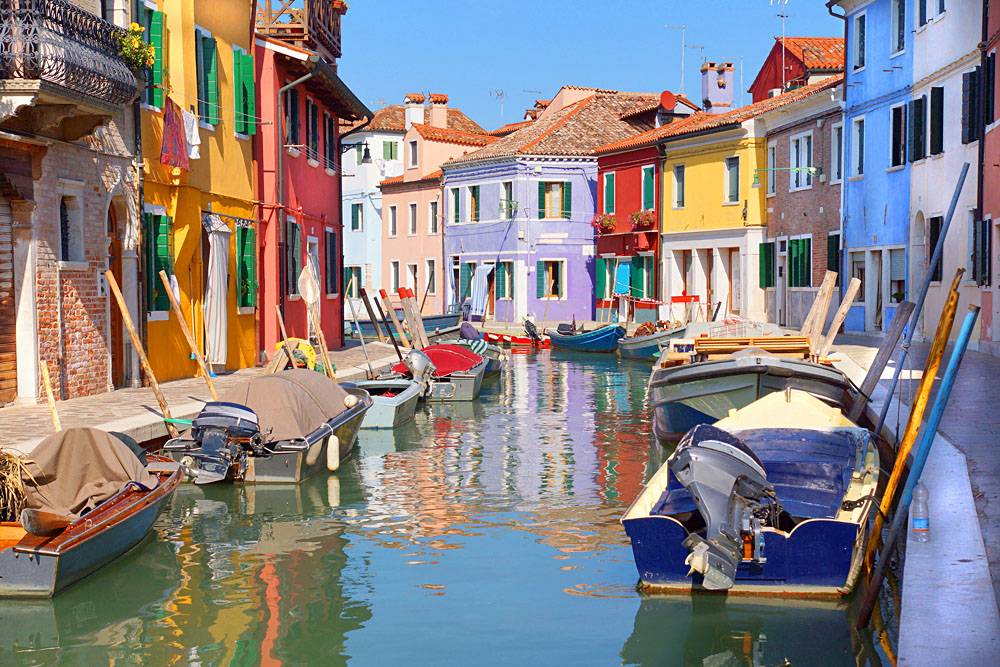 Colourful houses along a canal in the island of Burano in Venice, Italy