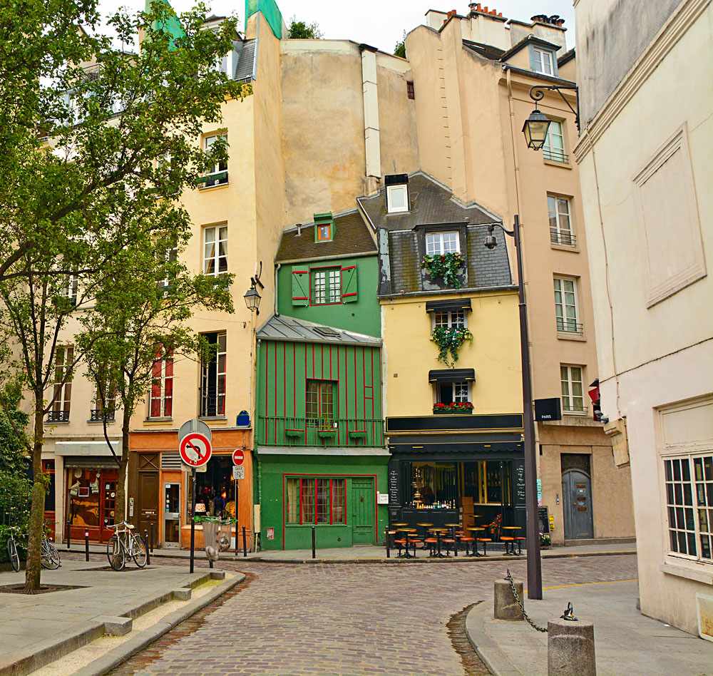 Narrow cobbled street among old traditional parisian houses in Latin Quarter of Paris, France