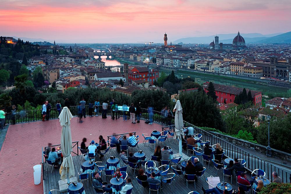 Tourists enjoying a panoramic view of Arno River from Piazzale Michelangelo at Sunset, Florence, Italy