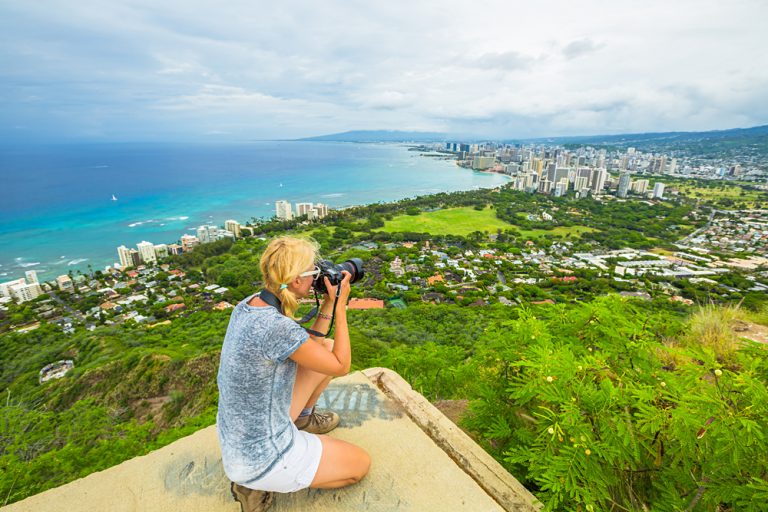 Woman Photographing Honolulu and Waikiki Beach from Diamond Head State Monument, Oahu, Hawaii, USA