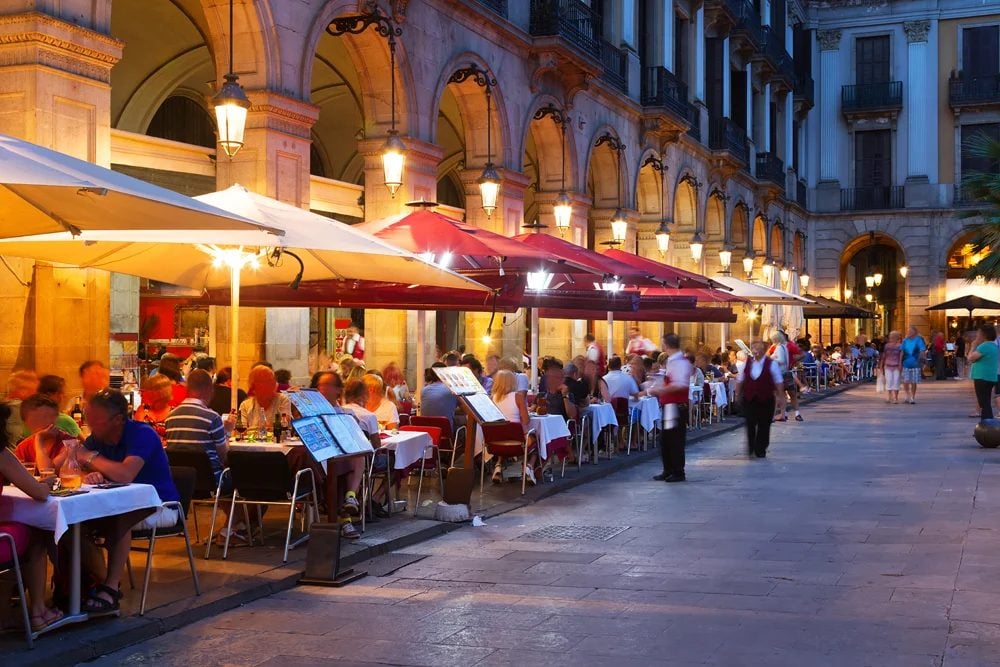 Street restaurants at Placa Reial in summer night, Barcelona, Spain