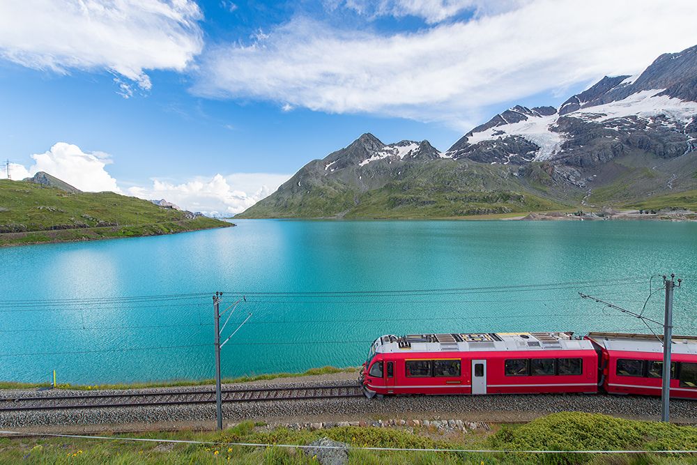 Red train in the high mountains of the Swiss Alps, Switzerland