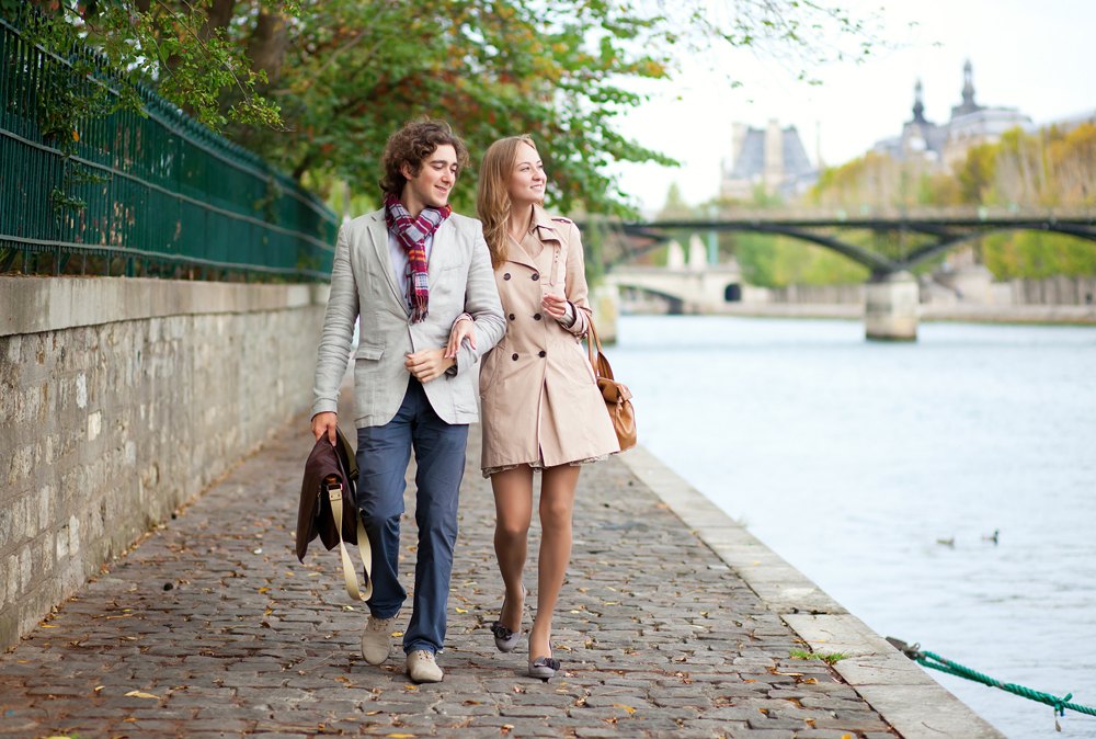 Romantic couple at the embankment of River Seine in Paris, France