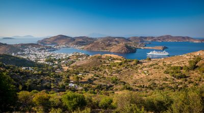 Skala village and port view with Celestyal Cruiseship in Patmos island, Greece Vacations