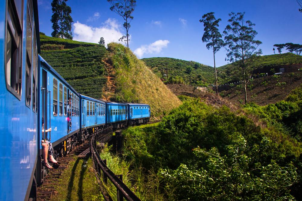 Train from Nuwara Eliya to Kandy among tea plantations in the highlands of Sri Lanka