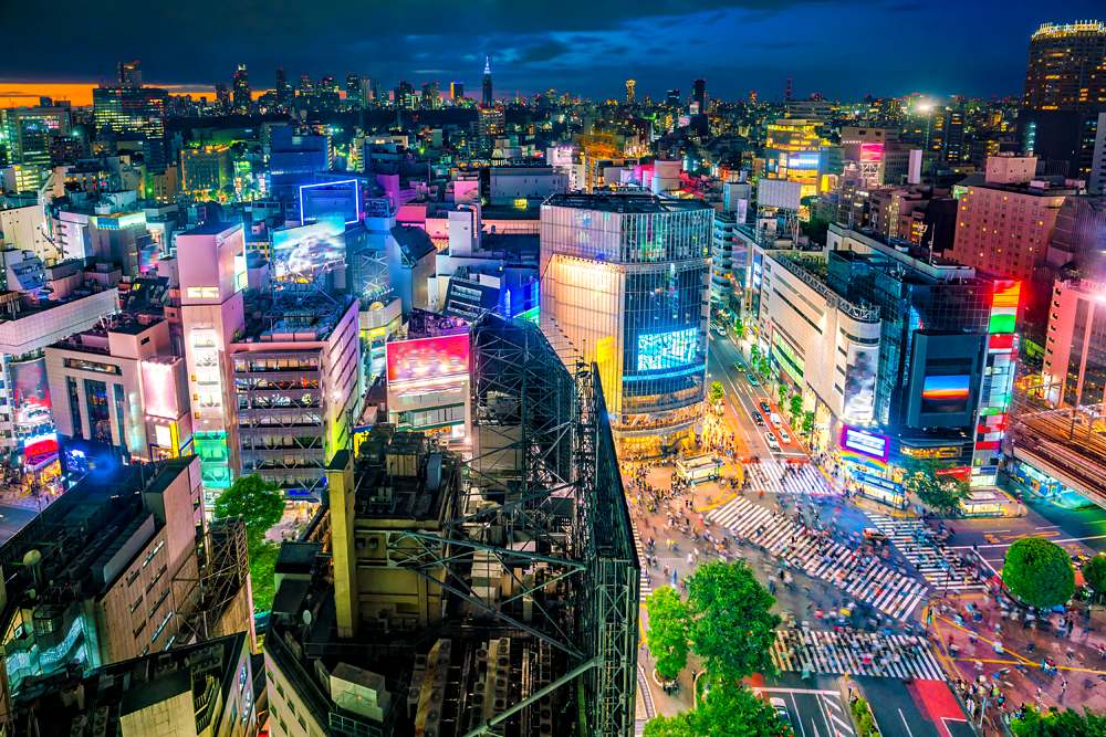 View of Shibuya Crossing and surrounding neon lights at twilight, Shibuya, Tokyo, Japan