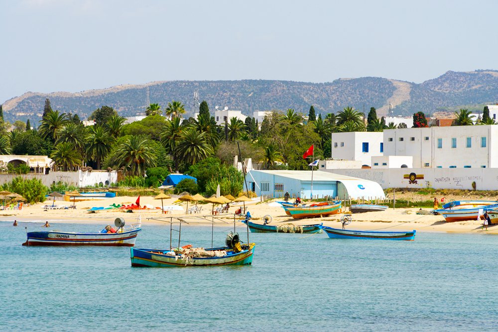 View of the beach, fishing boats, and sea in Hammamet, Tunisia
