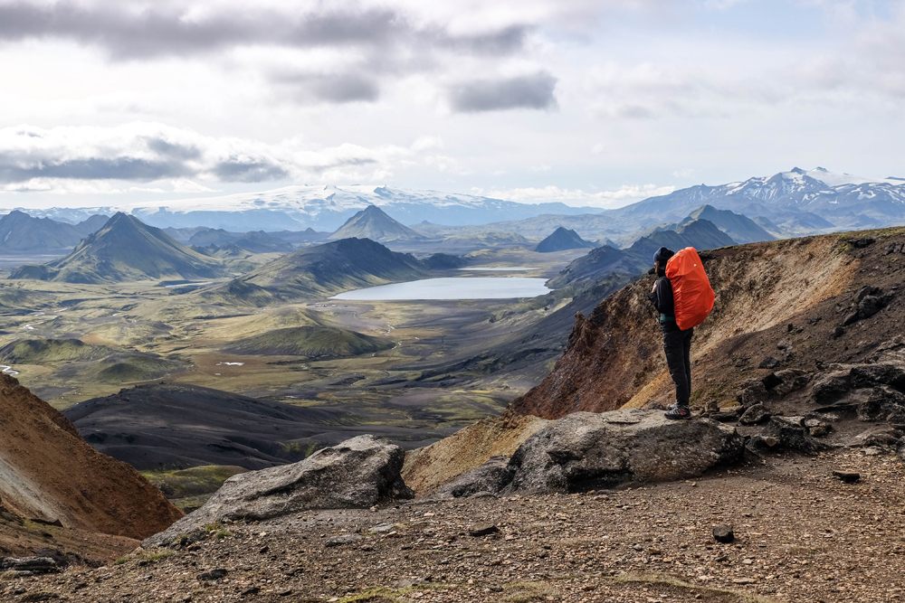 Woman hiker enjoying the view on lake Alftavatn in Iceland on Laugavegur trail, Iceland