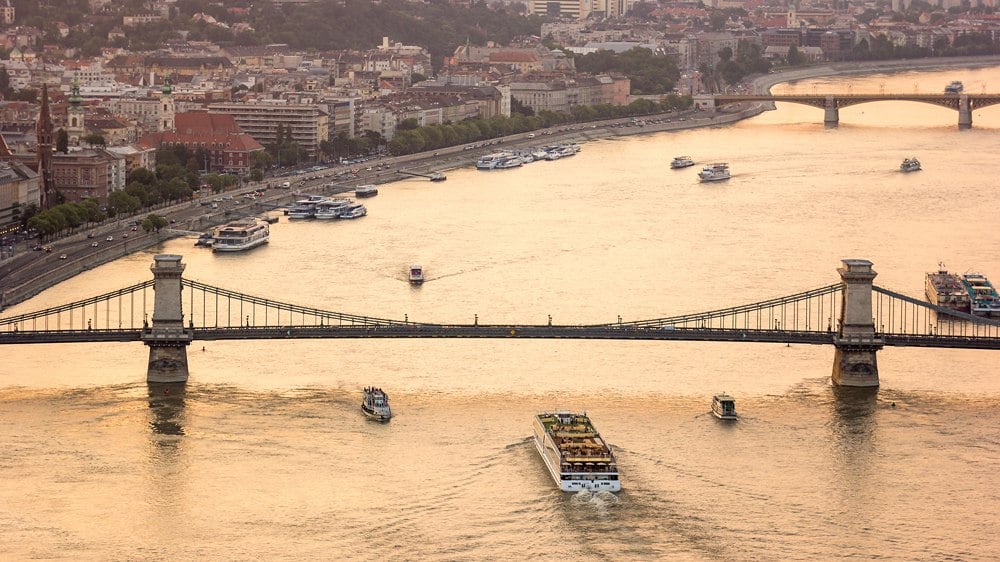 Sightseeing boat tours cruise Danube River under Chain Bridge, Budapest, Hungary
